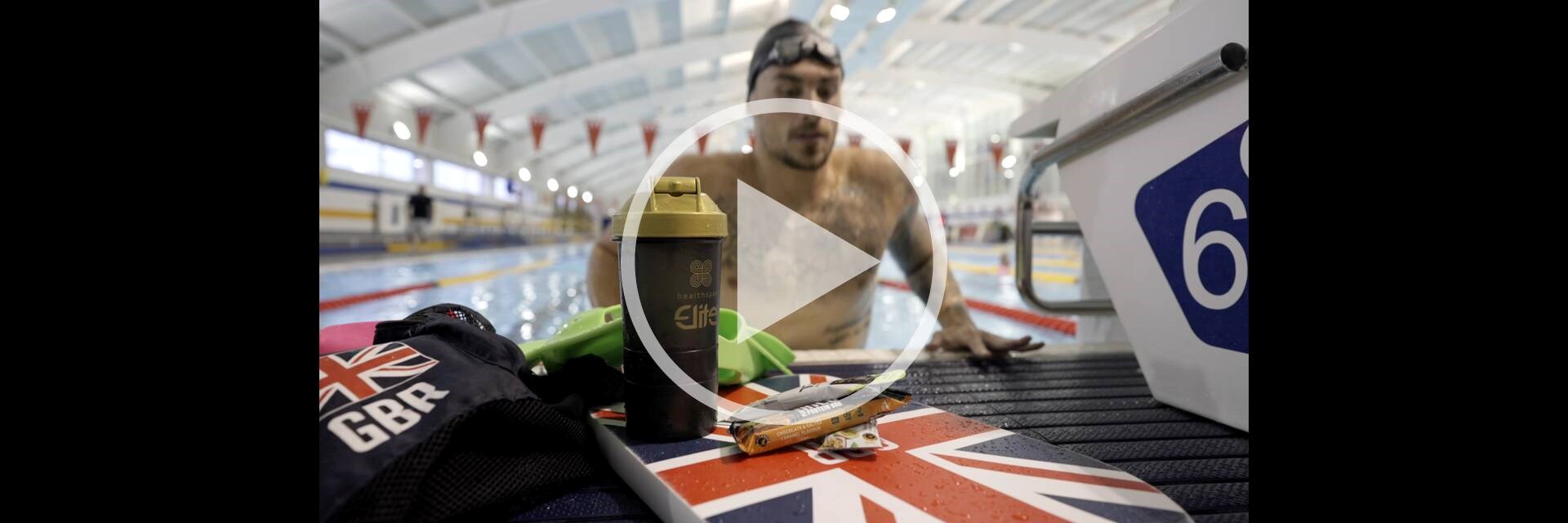 British Swimming athlete getting out of the pool next to Healthspan Elite products