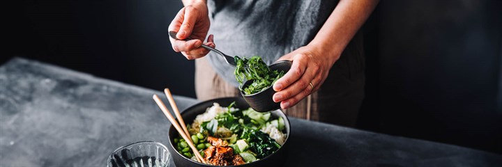 Man making a healthy stir-fry with protein and green vegetables