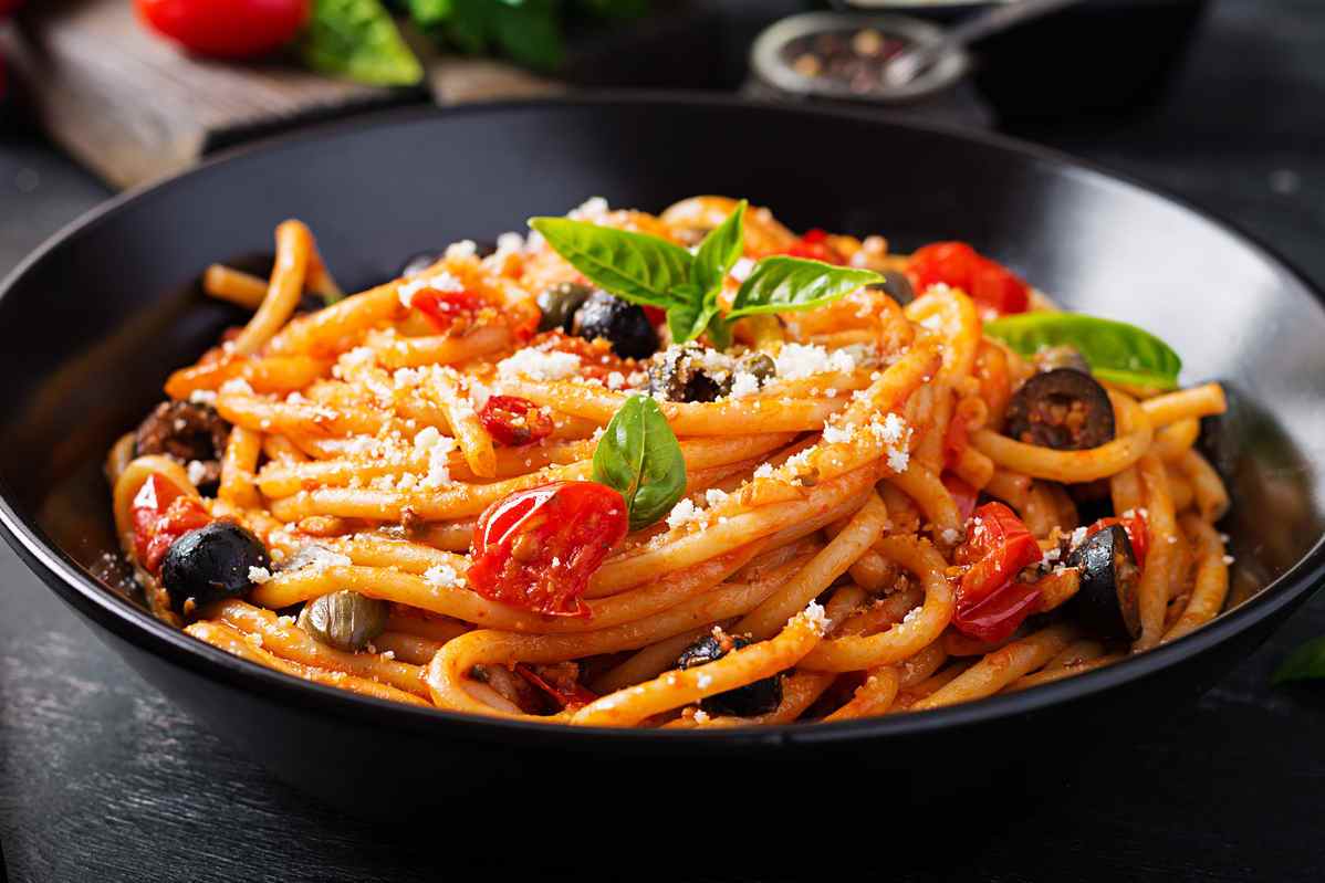Bowl of tomato and olive pasta