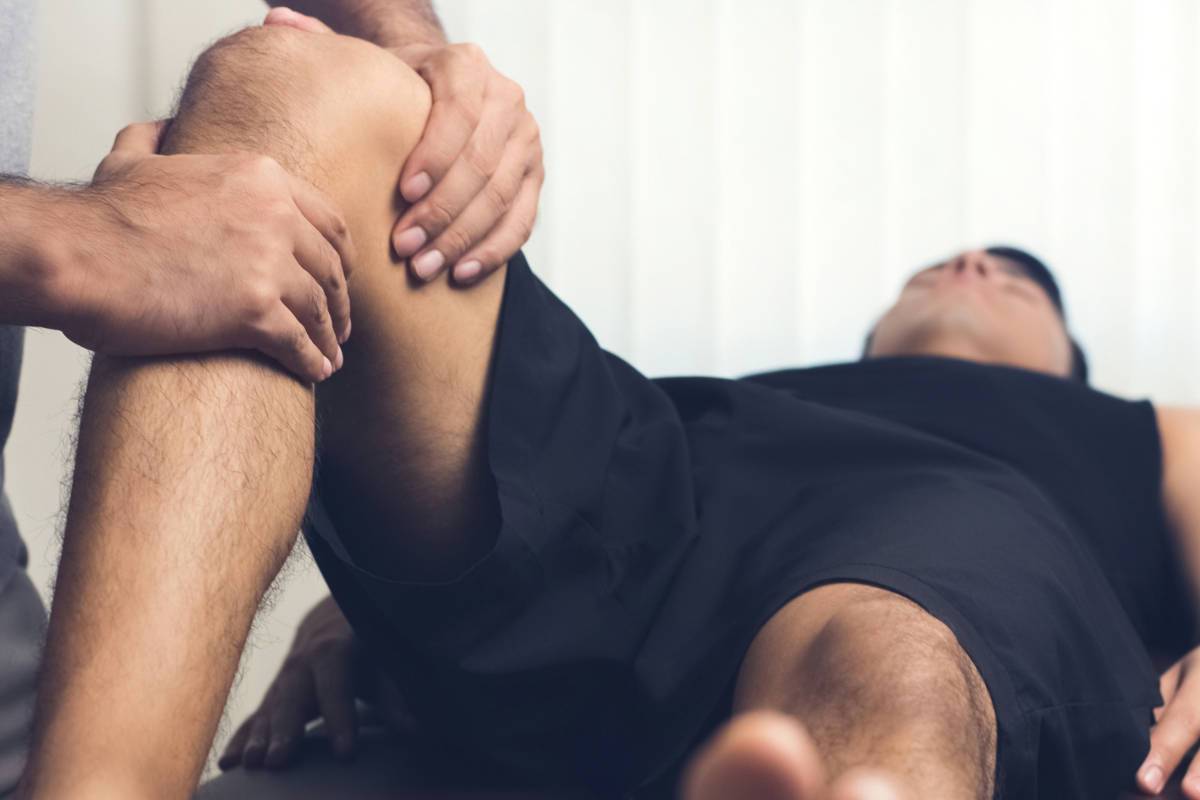 Man having physio on leg