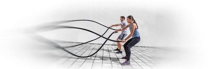 Man and woman working out with ropes