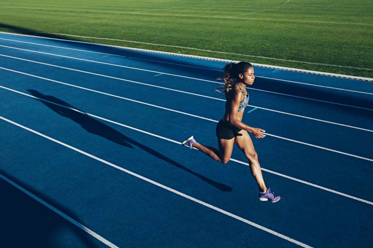 Female athlete running down track